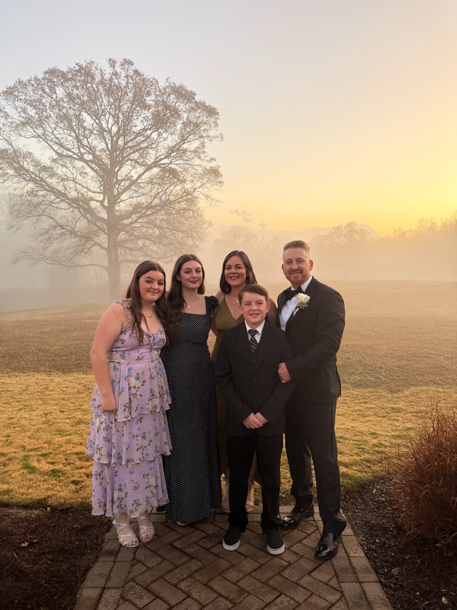 Victor Gluckin with Jess and their children outdoors in the evening light
